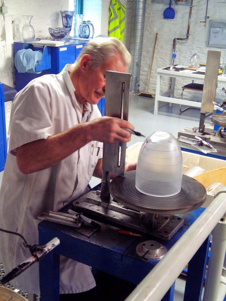 A image of a man creating a crystal vase. 