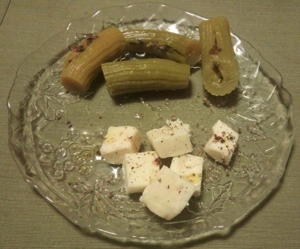 An image of pickled cucumbers and cheese.