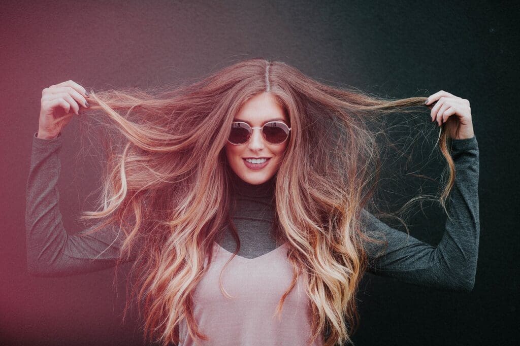 An image of a woman holding her hair