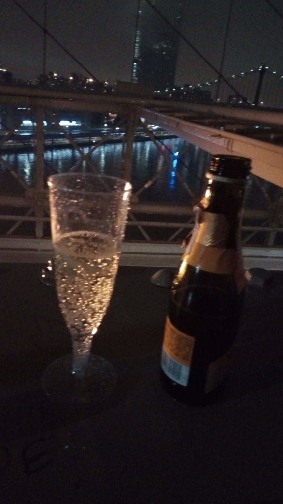 An image of a champagne glass on a bridge. 