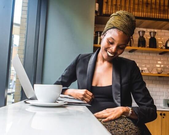 An image of a solo female traveler at a coffee shop. 