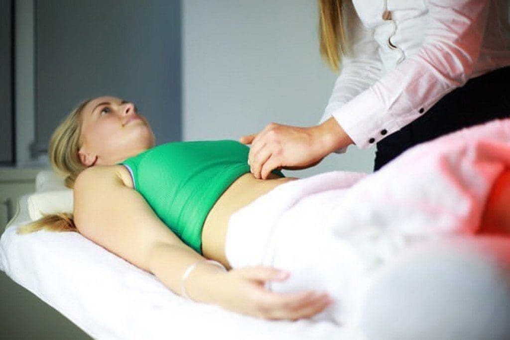 Woman receiving acupuncture from a doctor