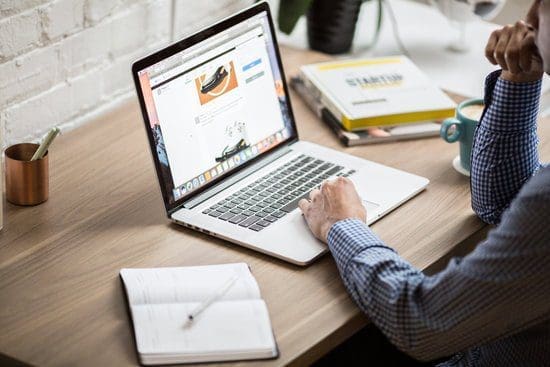 An image of a man updating his blog on his laptop