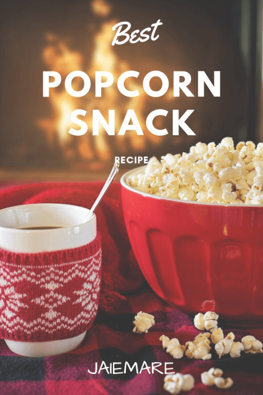 A bowl of popcorn sitting in front of a fireplace. 